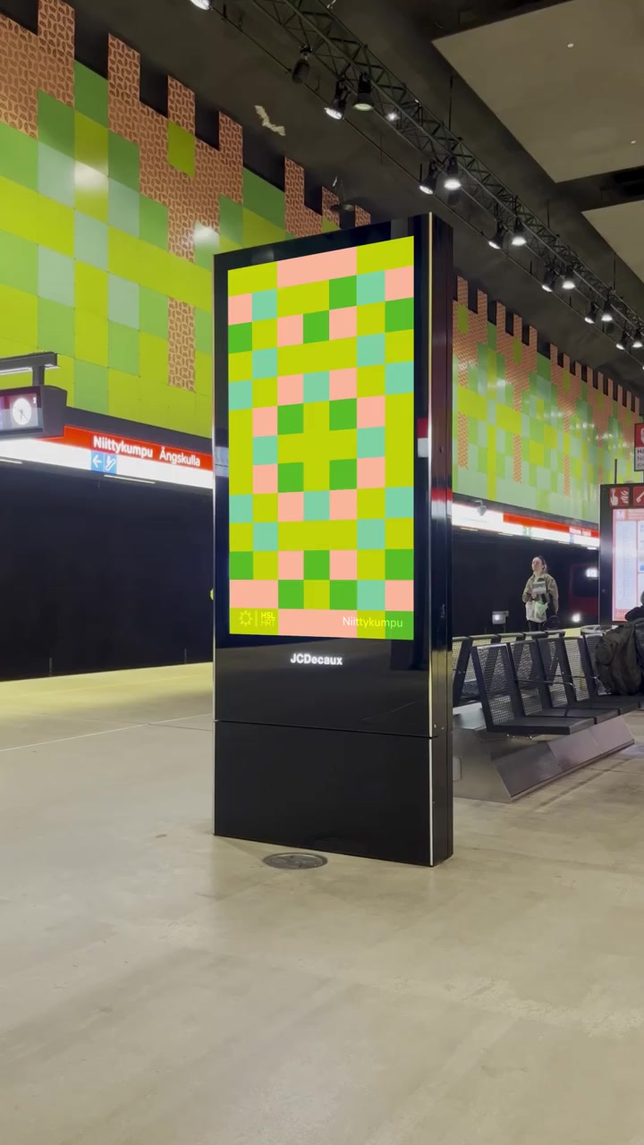 Green and yellow motion poster in Helsinki Metro